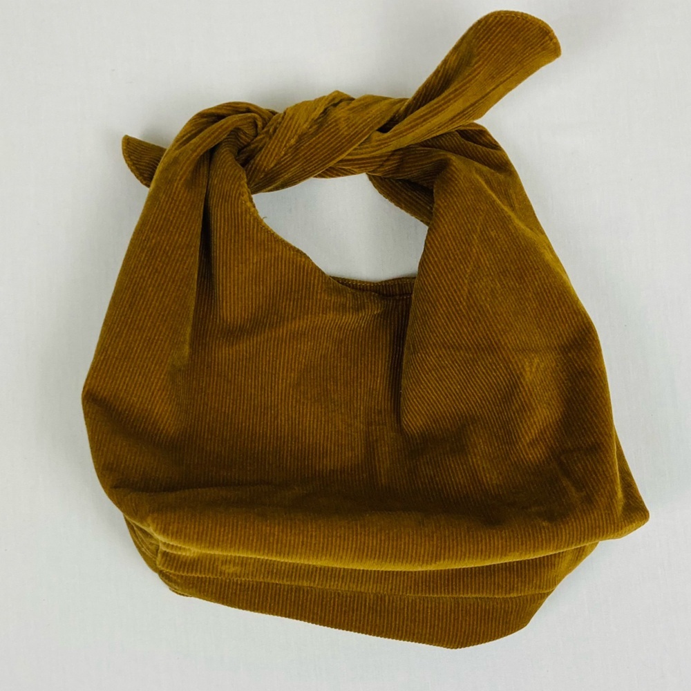 Merit brown corduroy signature tie top make up bag.
